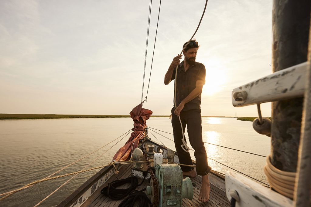 man sailing schooner