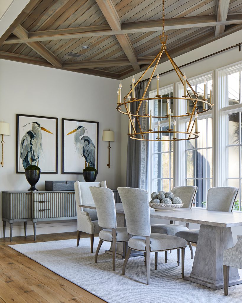 paintings of great herons near dining room table