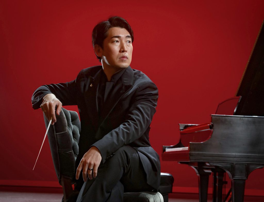 Best of Savannah honorable mention orchestra conductor Keitaro Harada sitting on piano bench