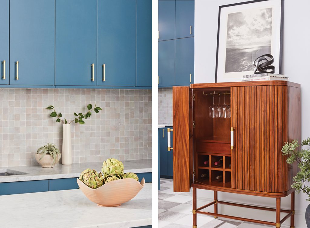 Blue kitchen cabinets and marble countertops with wooden wine bar