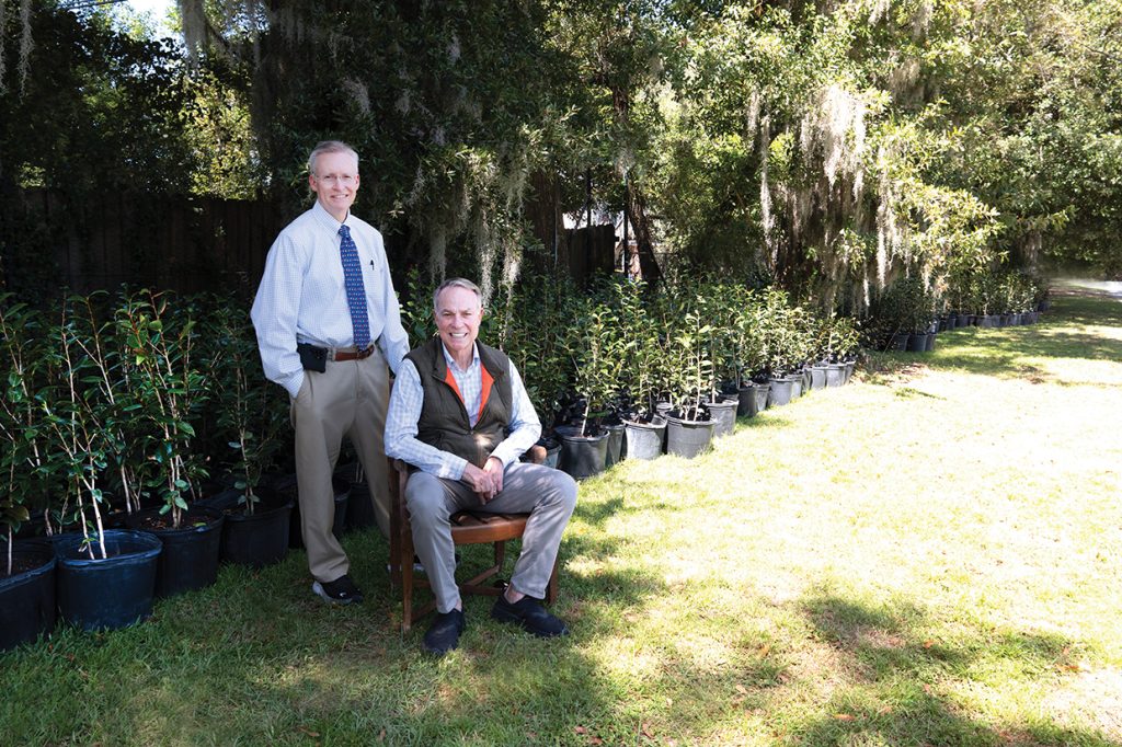 Dr. Sidney Smith and Don Waters with camellia plants
