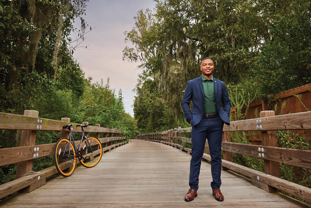 Armand Turner stands with a bike on the Truman Linear Park Trail