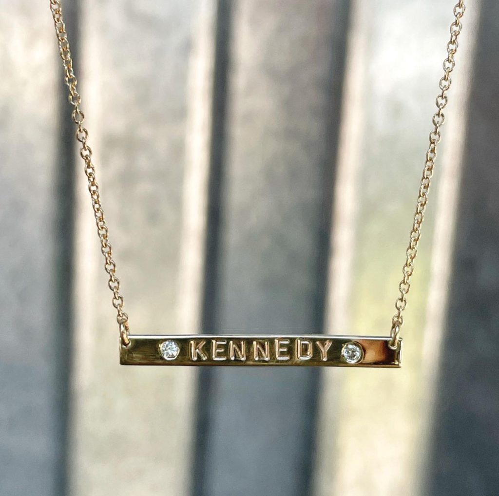 gold necklace with diamonds and engraved name