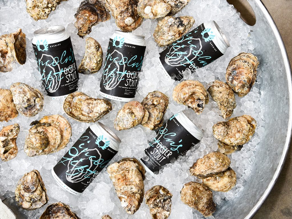 beer cans and oysters in a bucket of ice