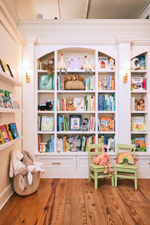 white shelves in a children's boutique filled with books and toys