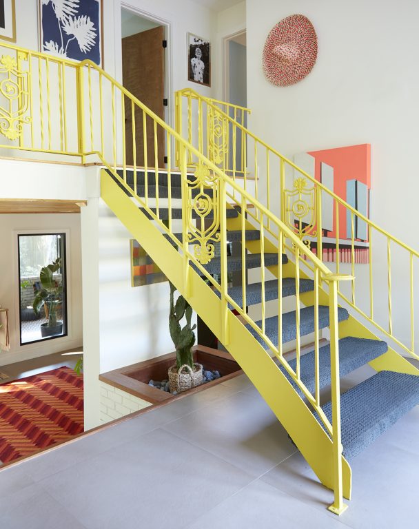 Bright yellow metal open staircase banister