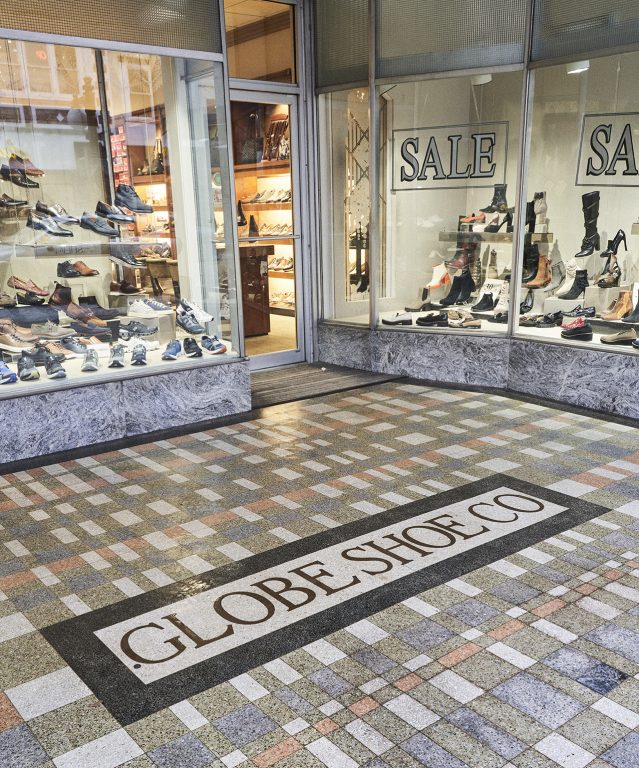 Pairs of shoes in window displays of Globe Shoe Co.