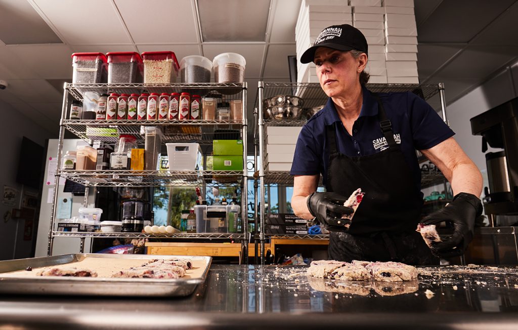 Woman in an industrial kitchen baking scones