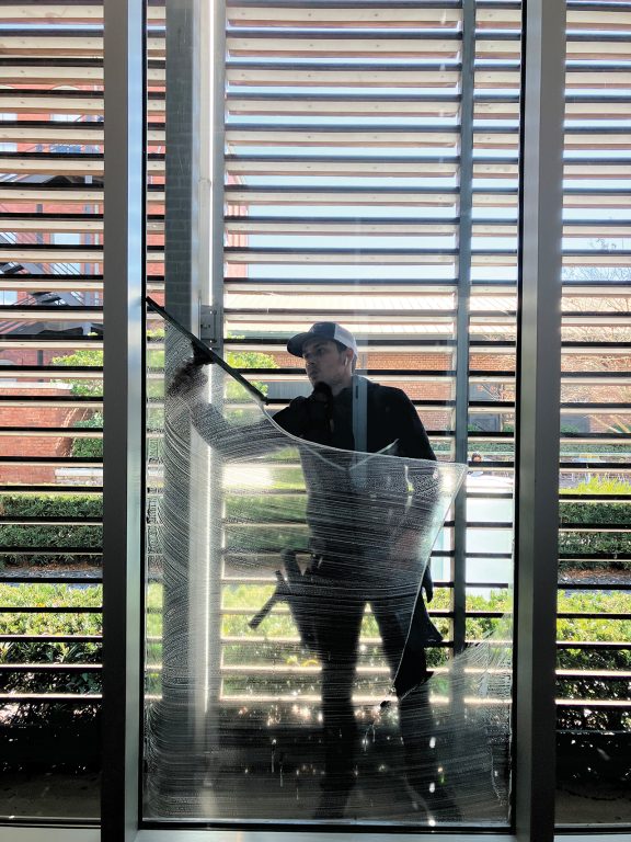 A person cleaning a window