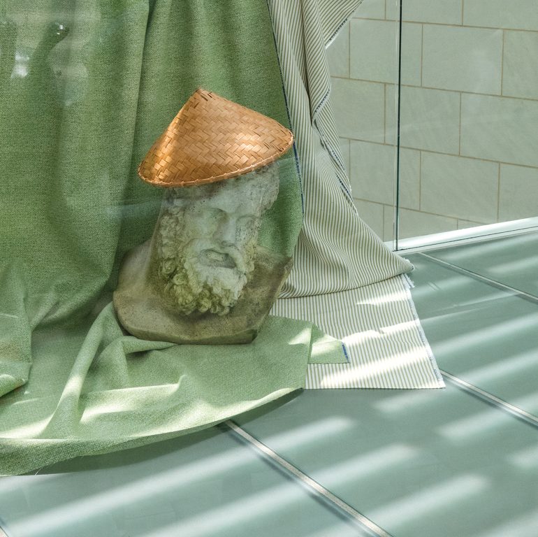 A decorative bust in a a vintage rice hat