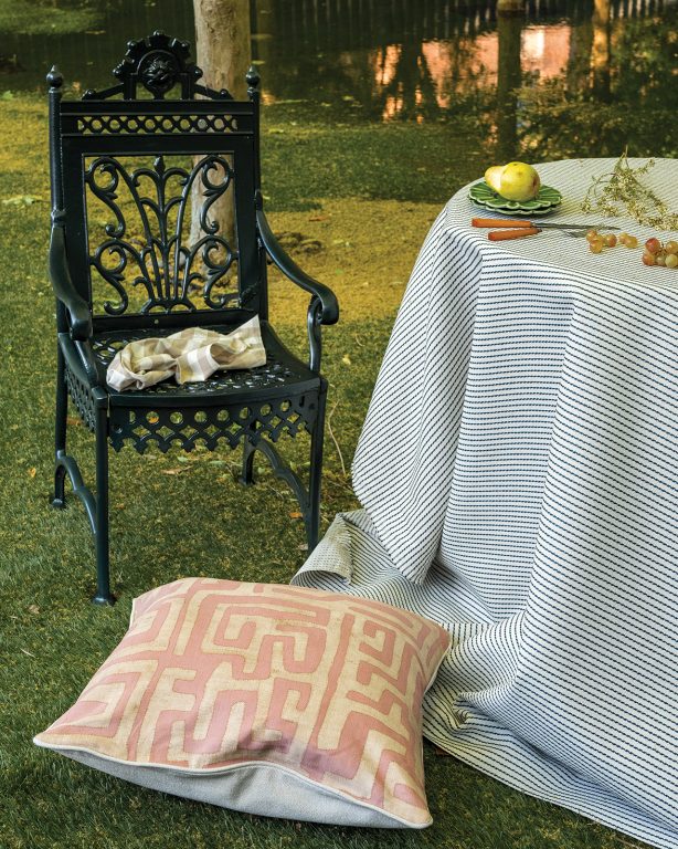 Cast iron garden chairs and table covered in a performance fabric table cloth