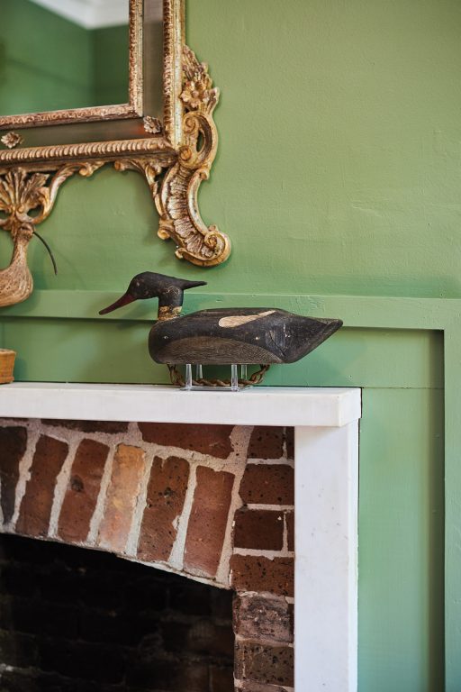 duck decoy on a fireplace mantel