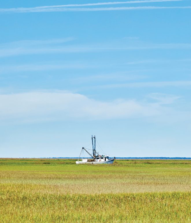 A shrimping boat on a river channel