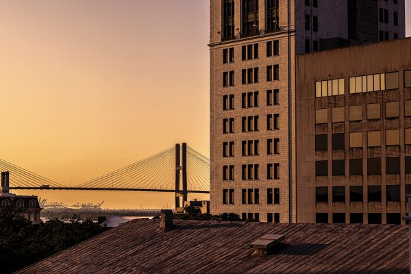 Tall buildings and suspension bridge in background