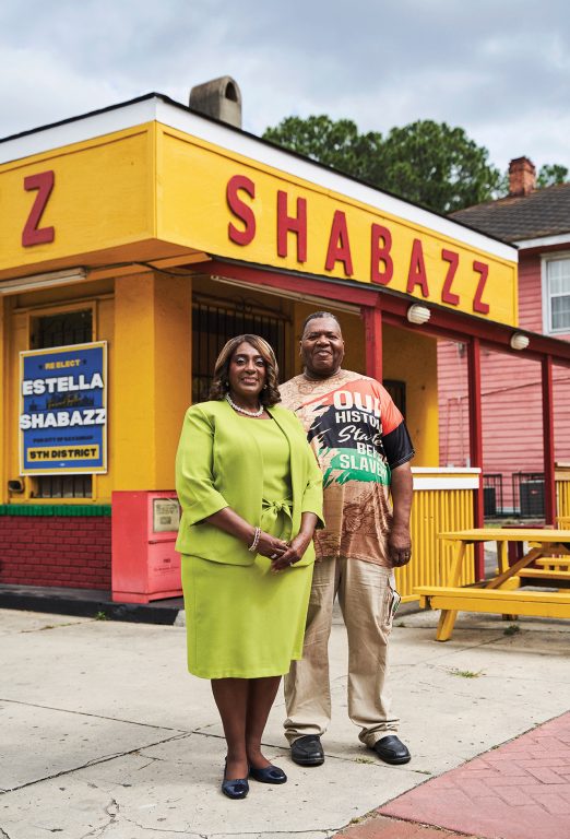 the owners of Shabazz standing in front of the restaurant