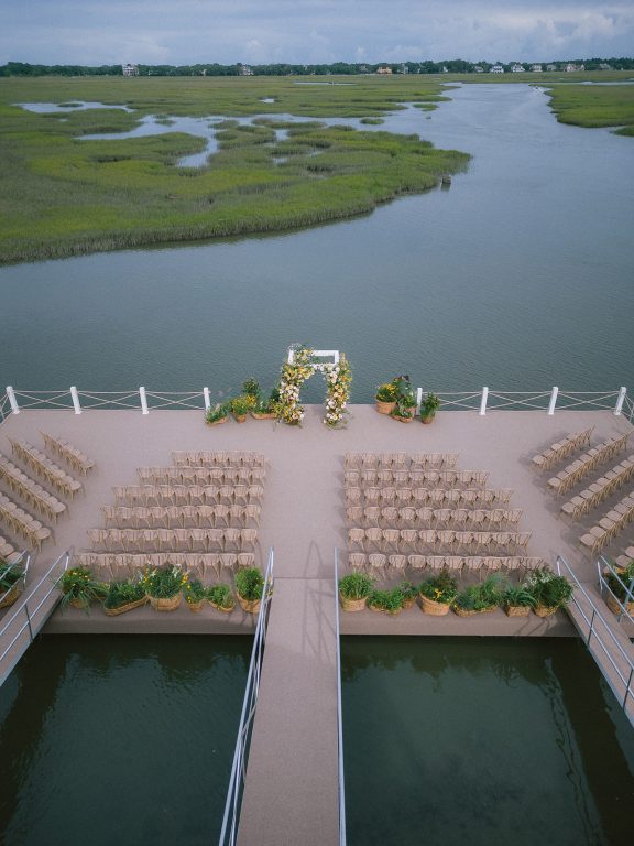 Dock decorated in flowers for a wedding overlooking the marsh and river