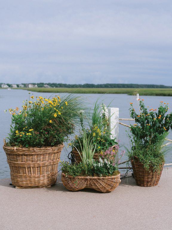 Baskets of flowers and potted plants on a dock