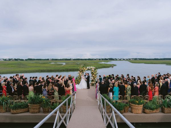 A couple getting married on a dock on the river