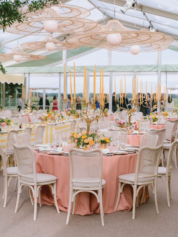 Tables set for wedding reception with tall candelabras
