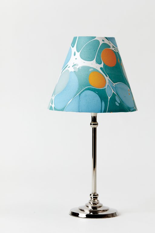 A table lamp with a brightly colored shade