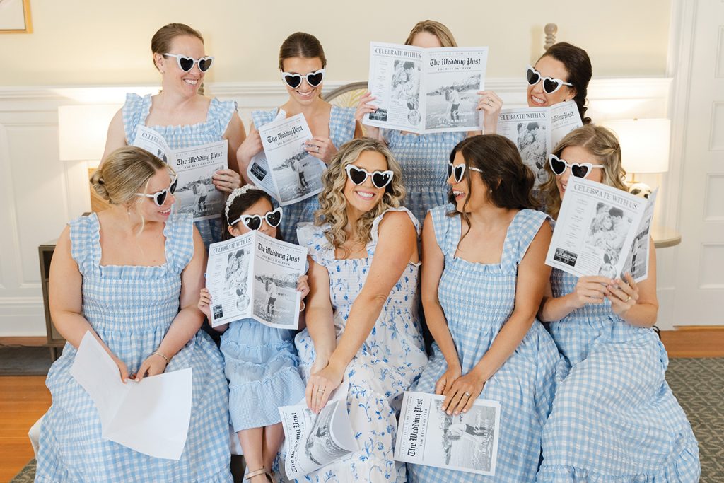 A bride surrounded by bridesmaids in blue and white checkered sun dresses