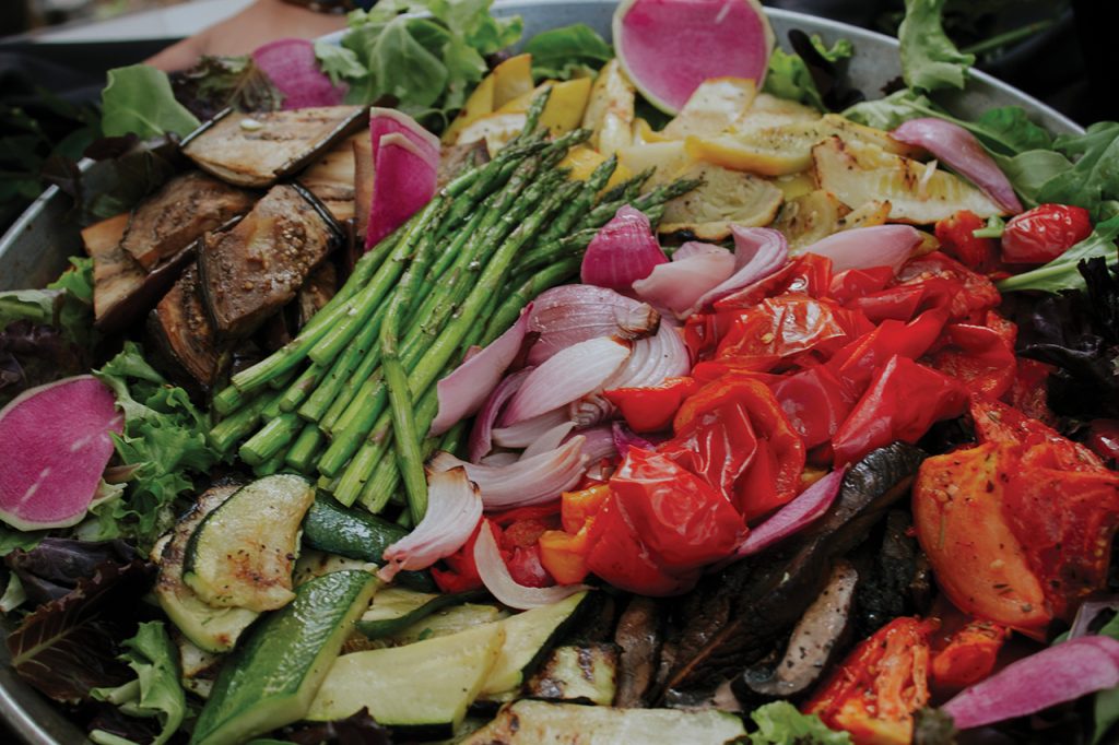 Platter filled with grilled onions, red peppers, egg plant, asparagus and zucchini