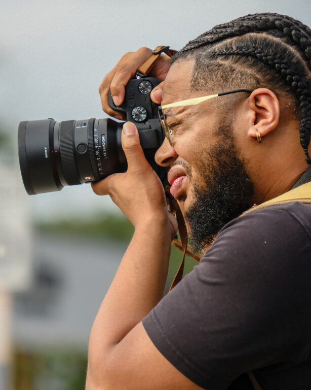 Black man taking photographs
