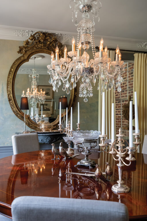 a crystal chandelier hanging above a dining room table