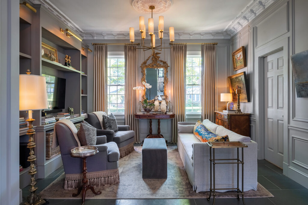 Antique furniture and paintings in the keeping room of a historic house
