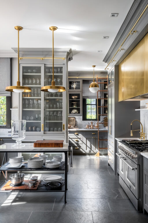 a gourmet kitchen with large slate tile floor and brass fixtures