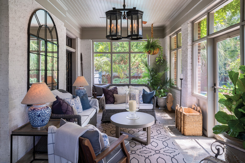 a screened in patio with whicker furniture