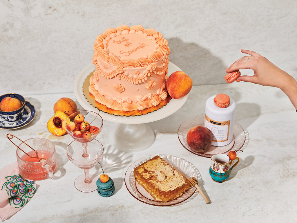 Cake with orange frosting, honey, peaches and tea