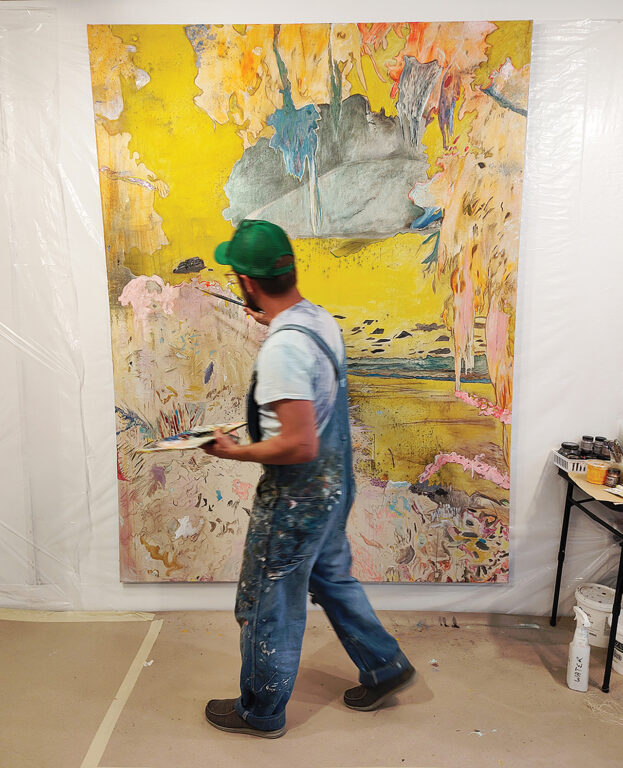 A man in overalls painting