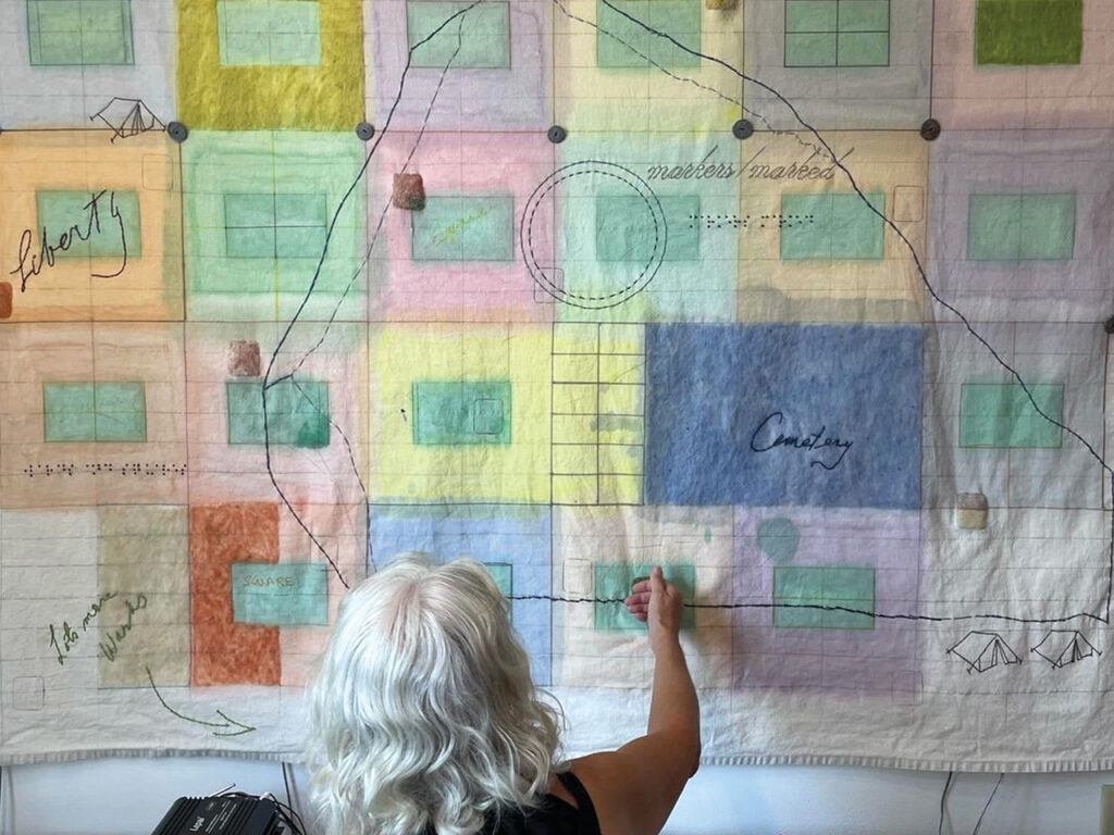 A woman touching a wall hanging