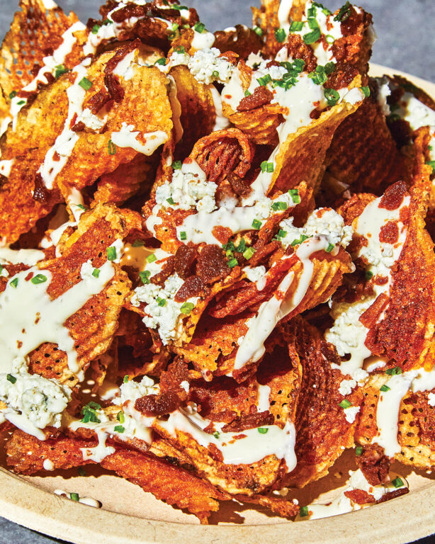 Waffle fries with dressing, scallions and bacon chunks
