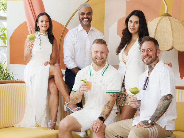 Three men and two women having drinks in a lounge