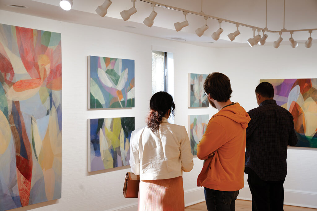 People looking at paintings in an art gallery