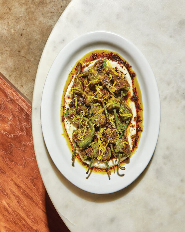 A plate of cooked padron peppers