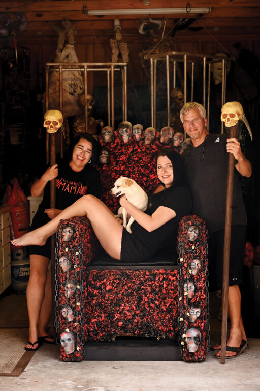 A family posing with halloween yard decorations