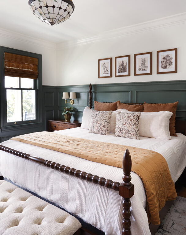 Bedroom with four-poster king bed and hunter green wainscoting