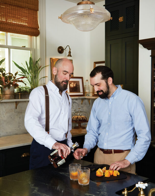 Jacob Jarvis and Jake Heroux enjoy a cocktail in their kitchen