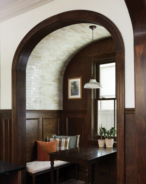 Dining nook with a barrel vaulted tiled ceiling and dark oak dining table
