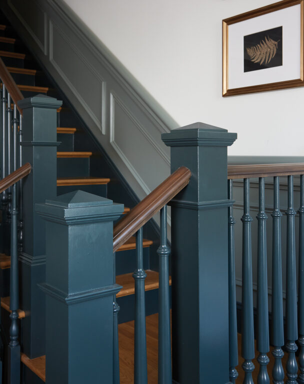 Stair railing and posts painted in a dark blue