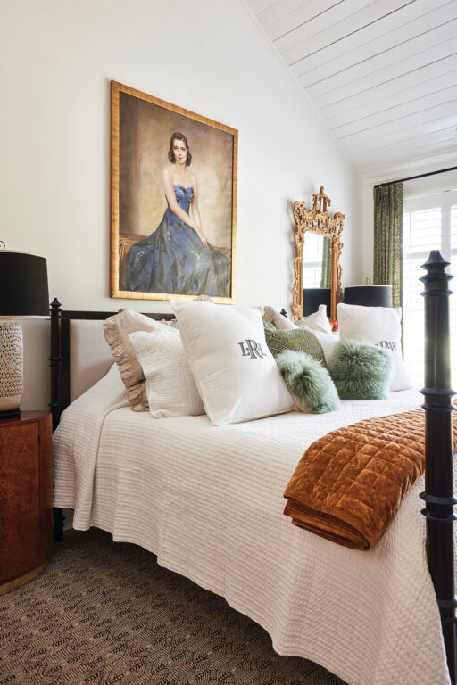 Four-poster bed with a painted portrait hanging above it