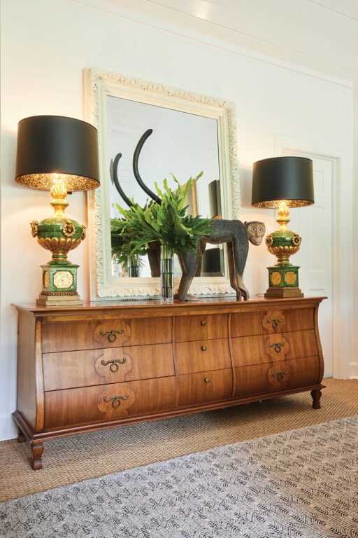 Antique chest of drawers with a monkey statue on top of it