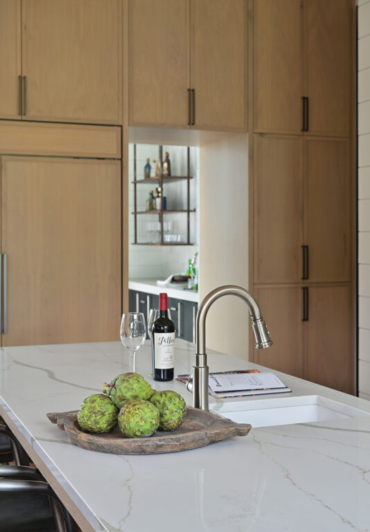 Marble kitchen countertop and light natural wood cabinets