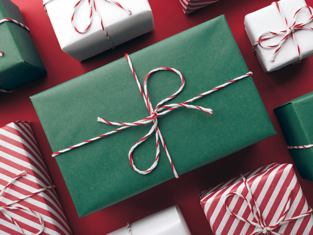 Gifts wrapped in red, white and green paper and bows