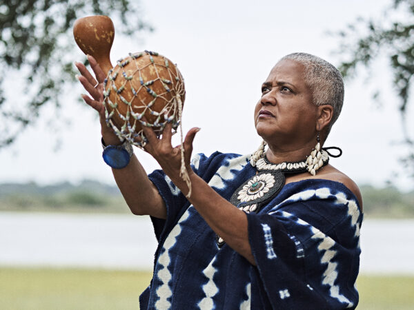Gulla Geechee Storyteller Lillian Grant Baptiste holds a decorative gourd