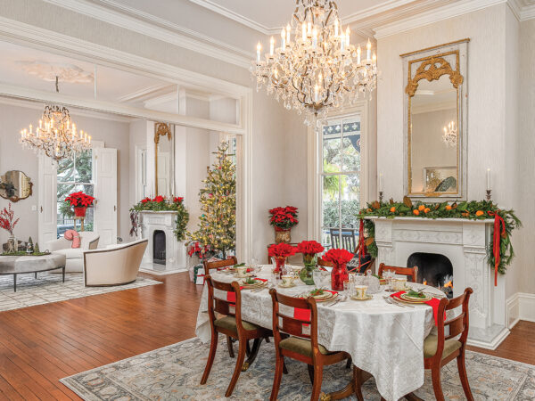 Living room and dining room of a Victorian home decorated for the holidays