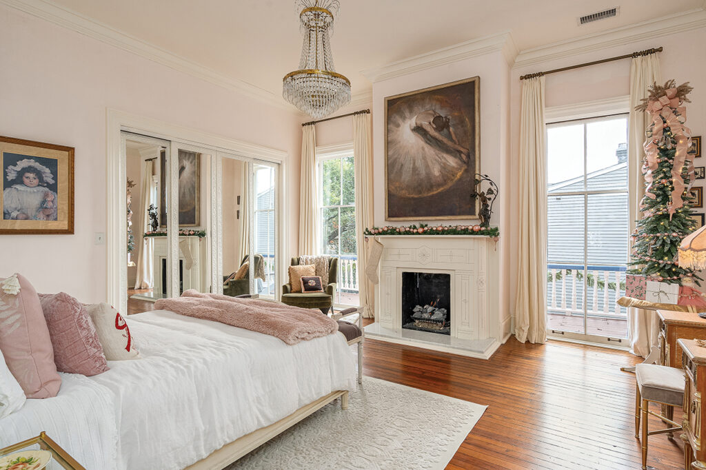 Victorian bedroom decorated with pink ornaments, a white beaded stocking and a Christmas tree with pink ornaments